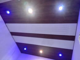 Modern white ceiling with dark border panels and spotlights