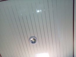 Wood and white feature ceiling with blue geometric lighting