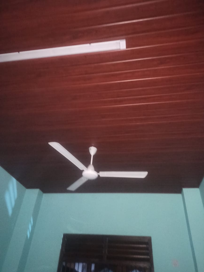 Wood panel ceiling with ceiling fan and linear light