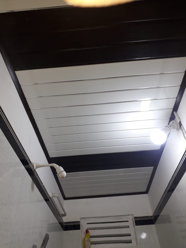 White and dark panel ceiling with linear recessed lighting
