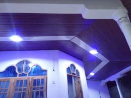 Wood-finish false ceiling with recessed blue lighting